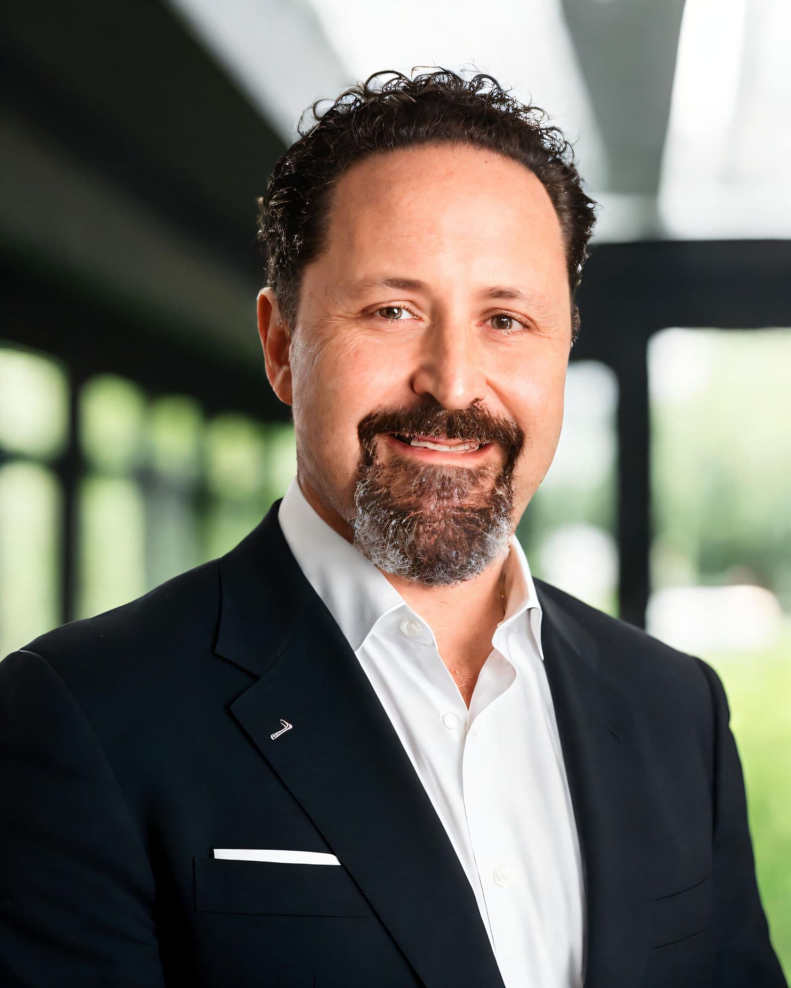 Joe Farro, Certified Mortgage Planner and mortgage broker at Home Express Mortgage, in a navy jacket and white shirt, against a blurred indoor background